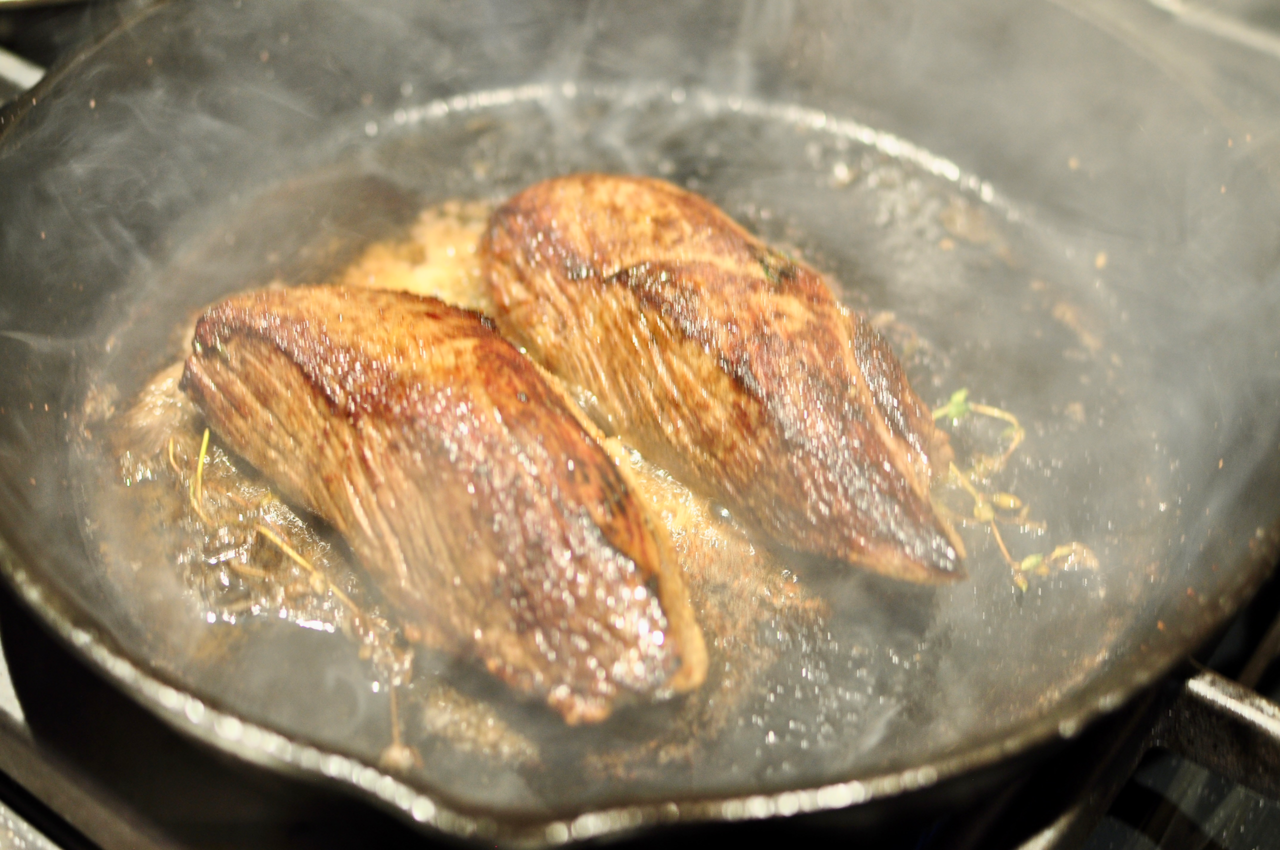 Grilling steak of hot cast iron pan