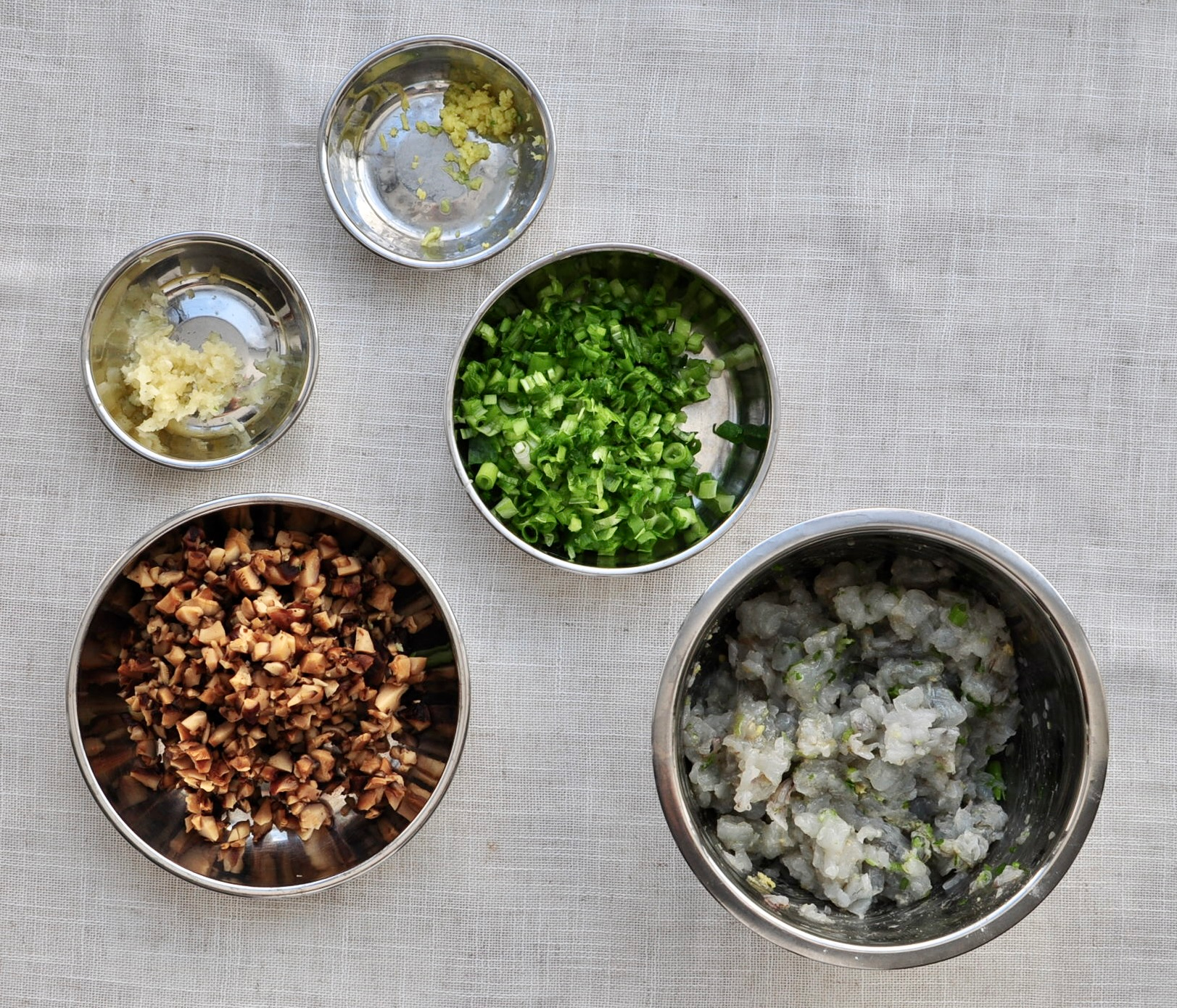Ingredients for wontons chopped and minced shiitake mushrooms, shrimp, scallions
