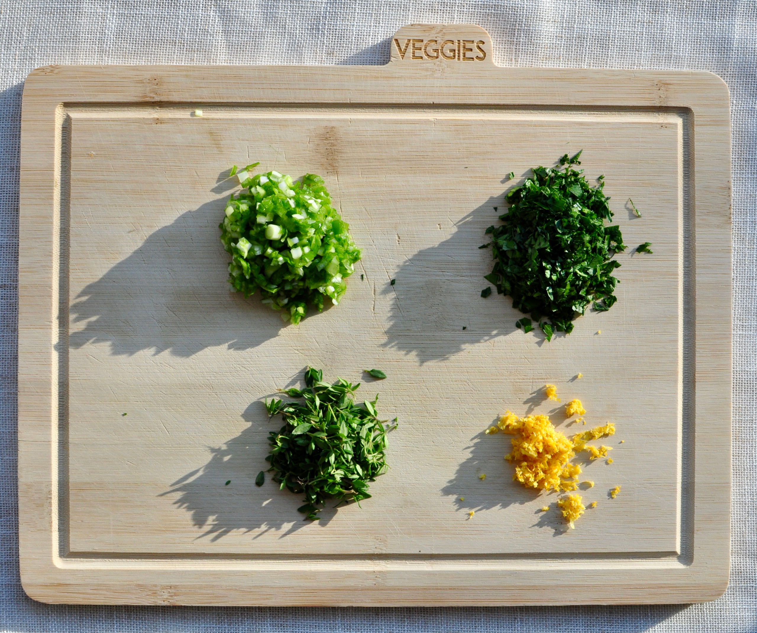 minced herbs for compound butter, scallions, lemon zest, parsley, thyme