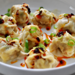 Pork and Shrimp Wonton Recipe Served with Scallions and Chili Crisp Oil