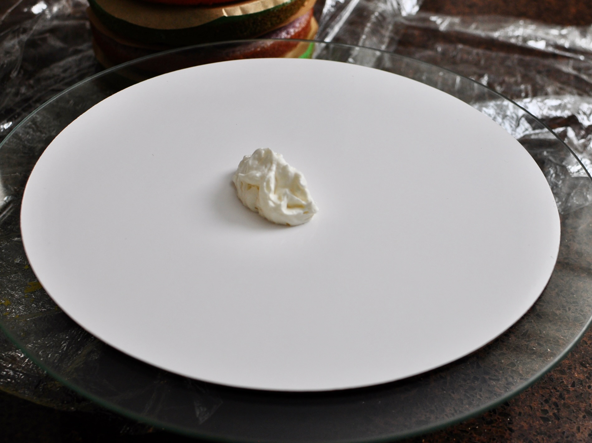 Dab of whipped cream on cake board