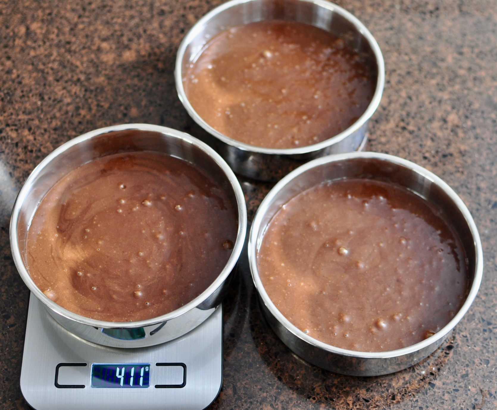Divide chocolate cake batter evenly between cake pans