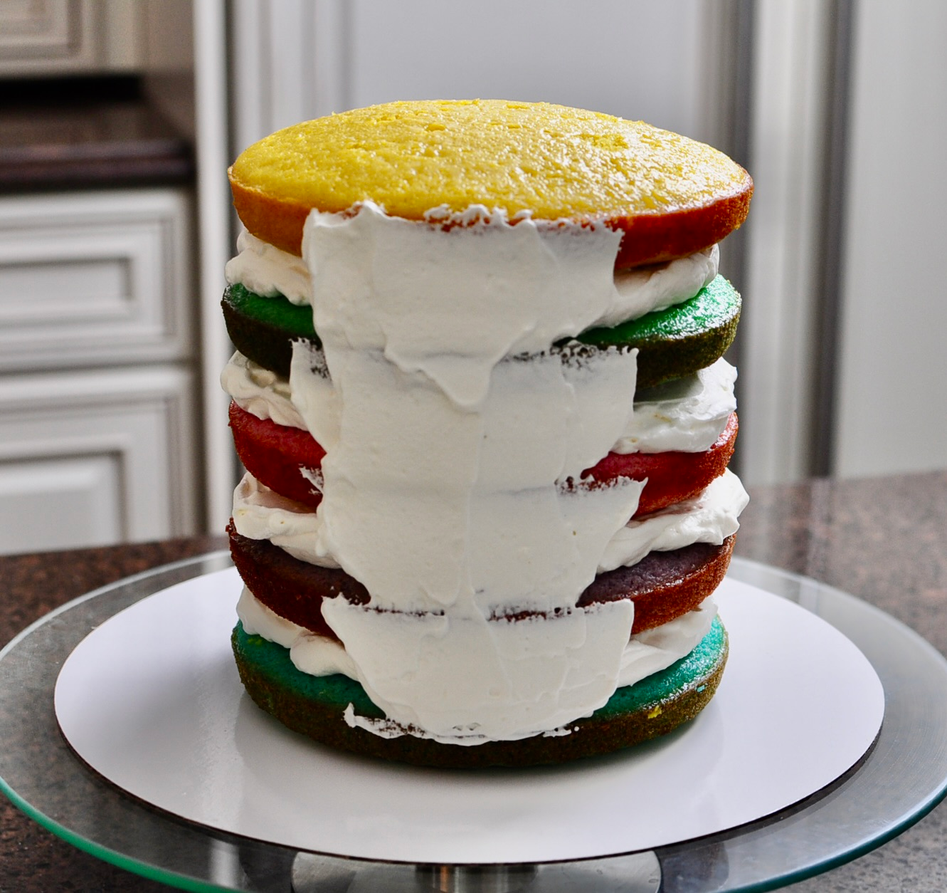 Frosting a 5 layer rainbow cake