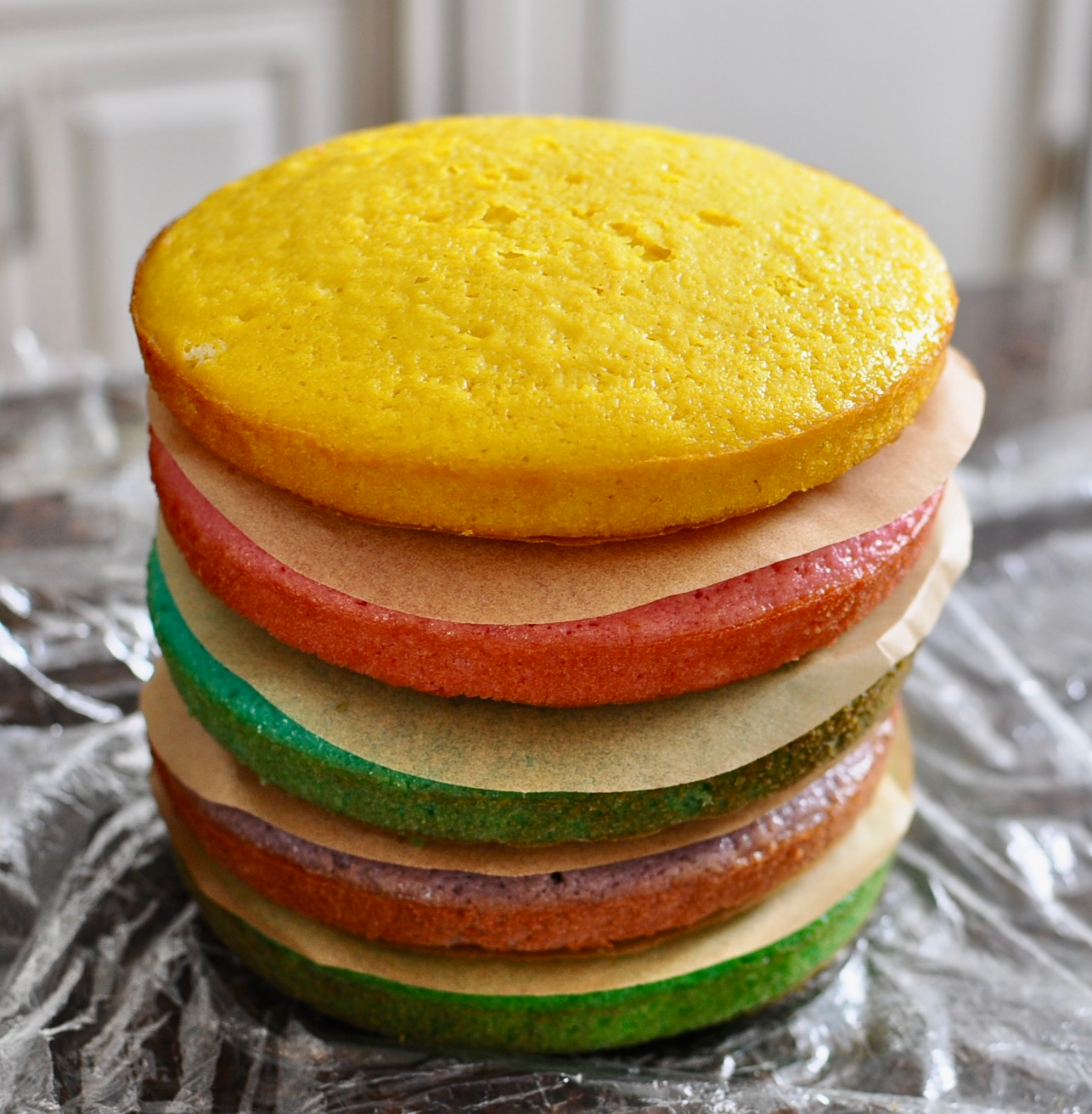 Rainbow cake stacked to store in fridge