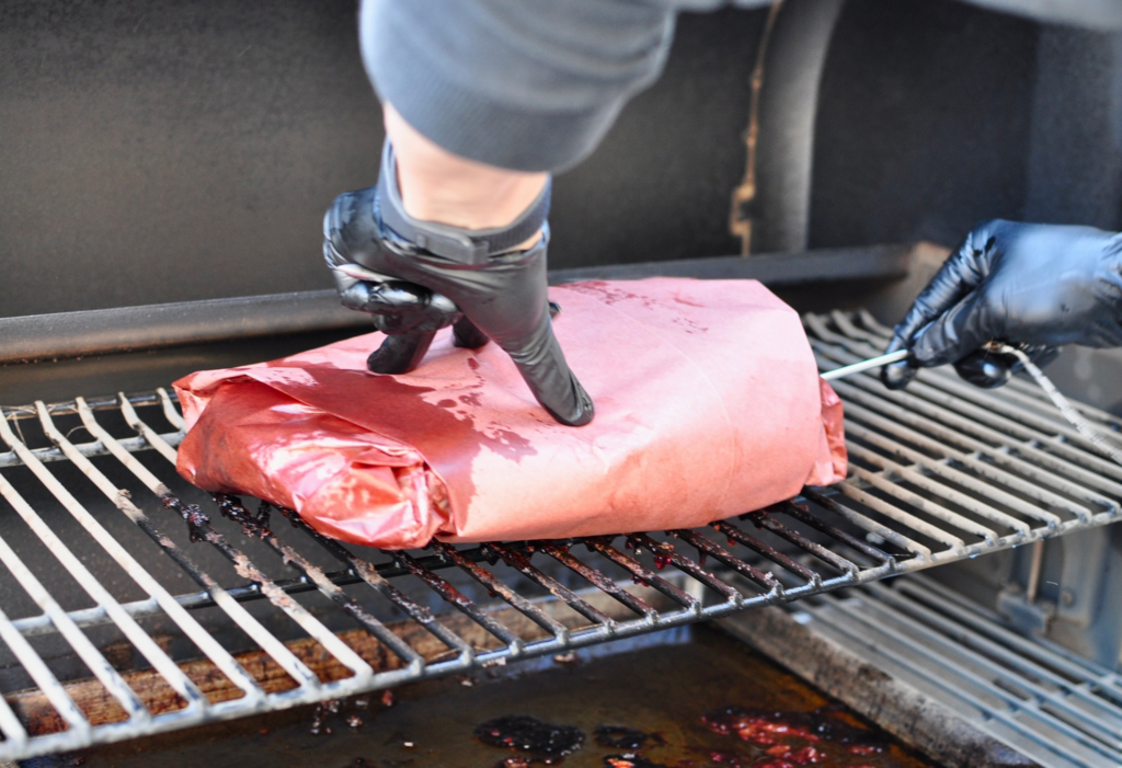 Inserting thermometer on to brisket