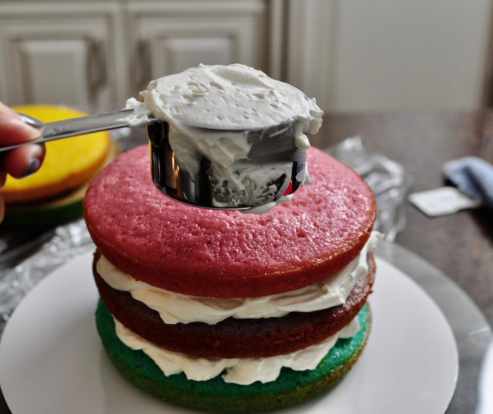 Whipped cream frosting between layers of vanilla cake