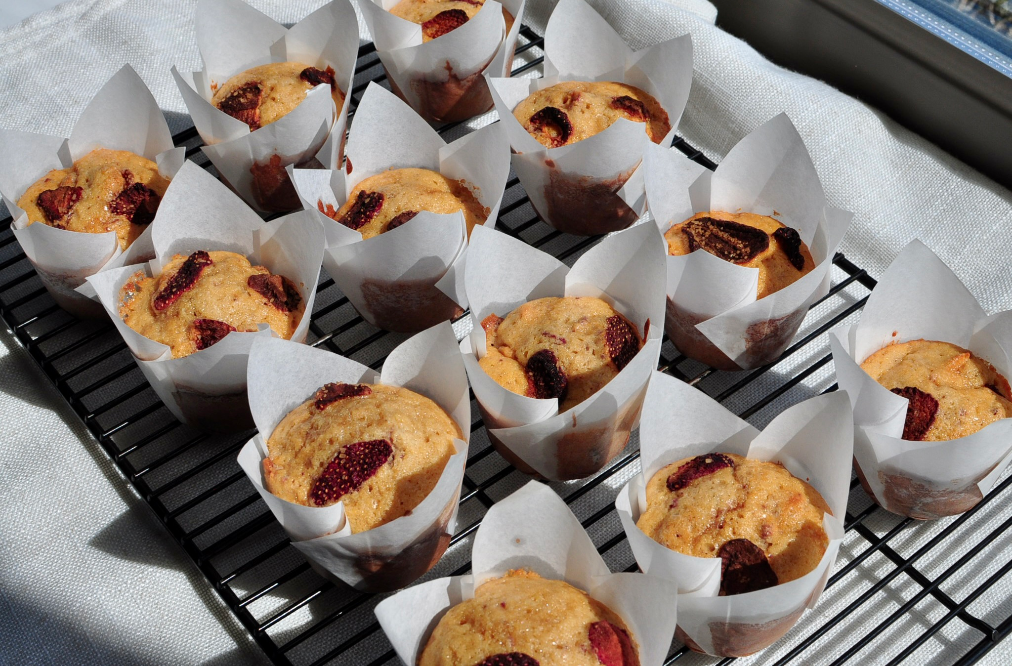Baked Strawberry Muffins cooling on wire rack