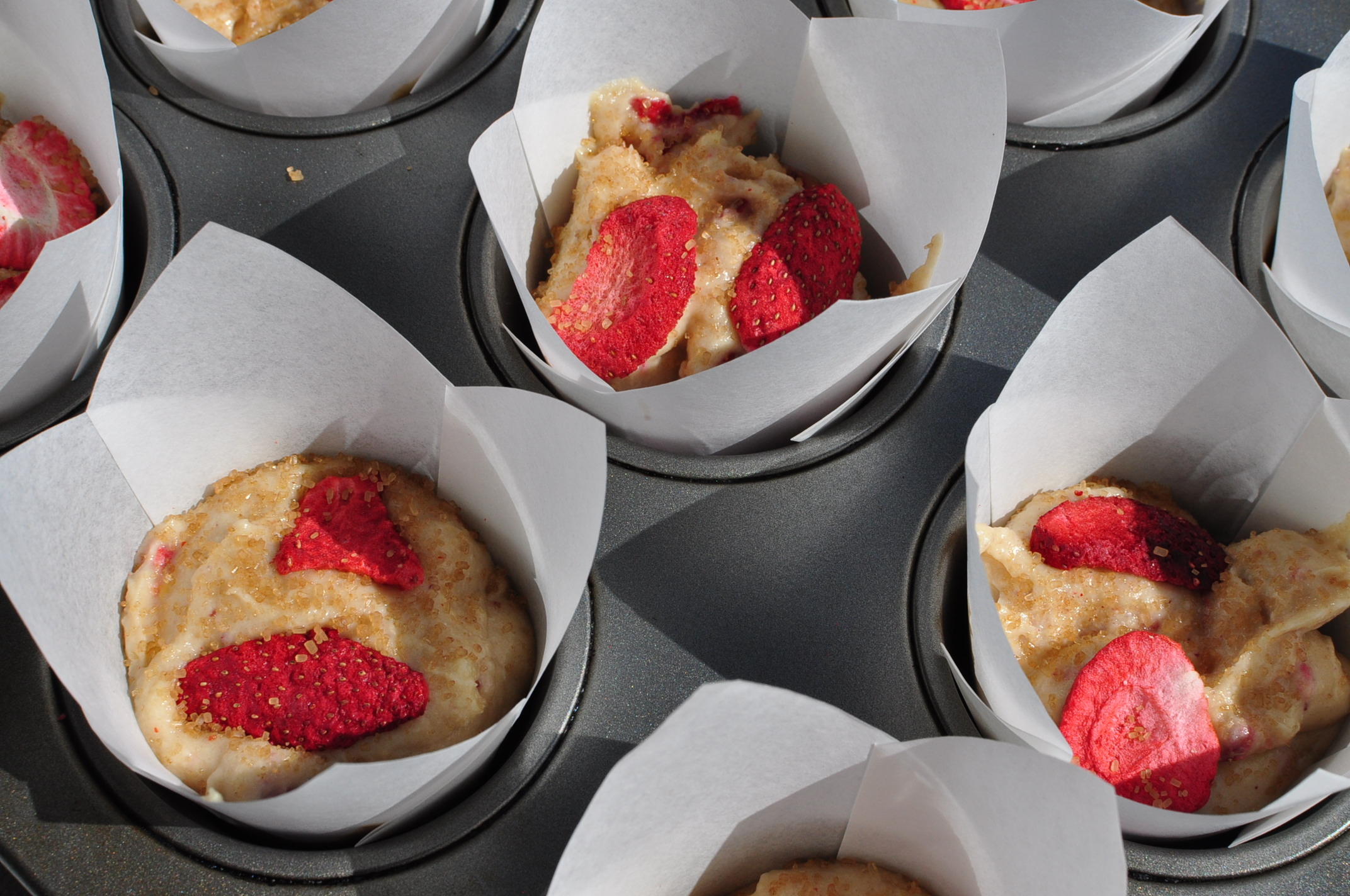 strawberry muffins topped with turbinado sugar