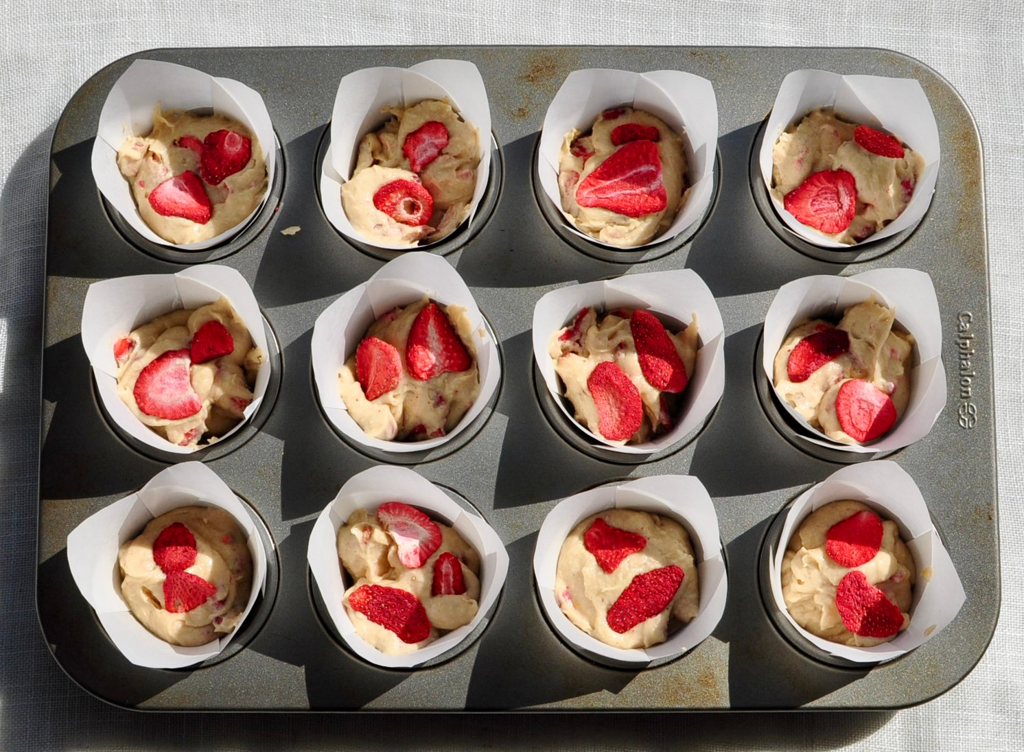 strawberry muffins in muffin tins before baking