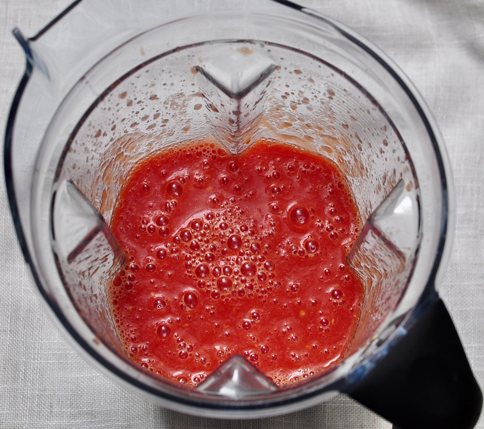 Whole peeled tomatoes pureed in blender for homemade meat sauce
