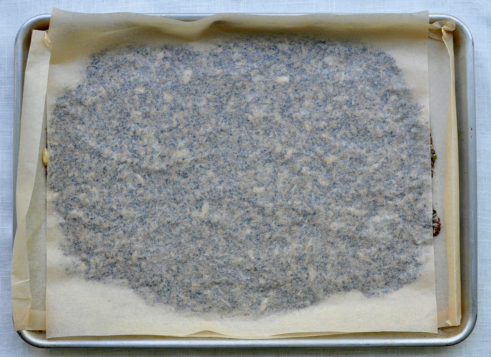 Flatten Seed Mixture Between Parchment Paper for Thin Seed Crackers