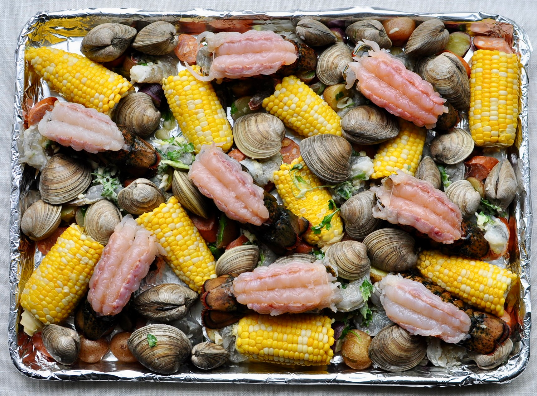 Sheet Pan Clam Bake with Corn, Potatoes, Andouille Sausage, Shrimp, Clams and Lobster Tail
