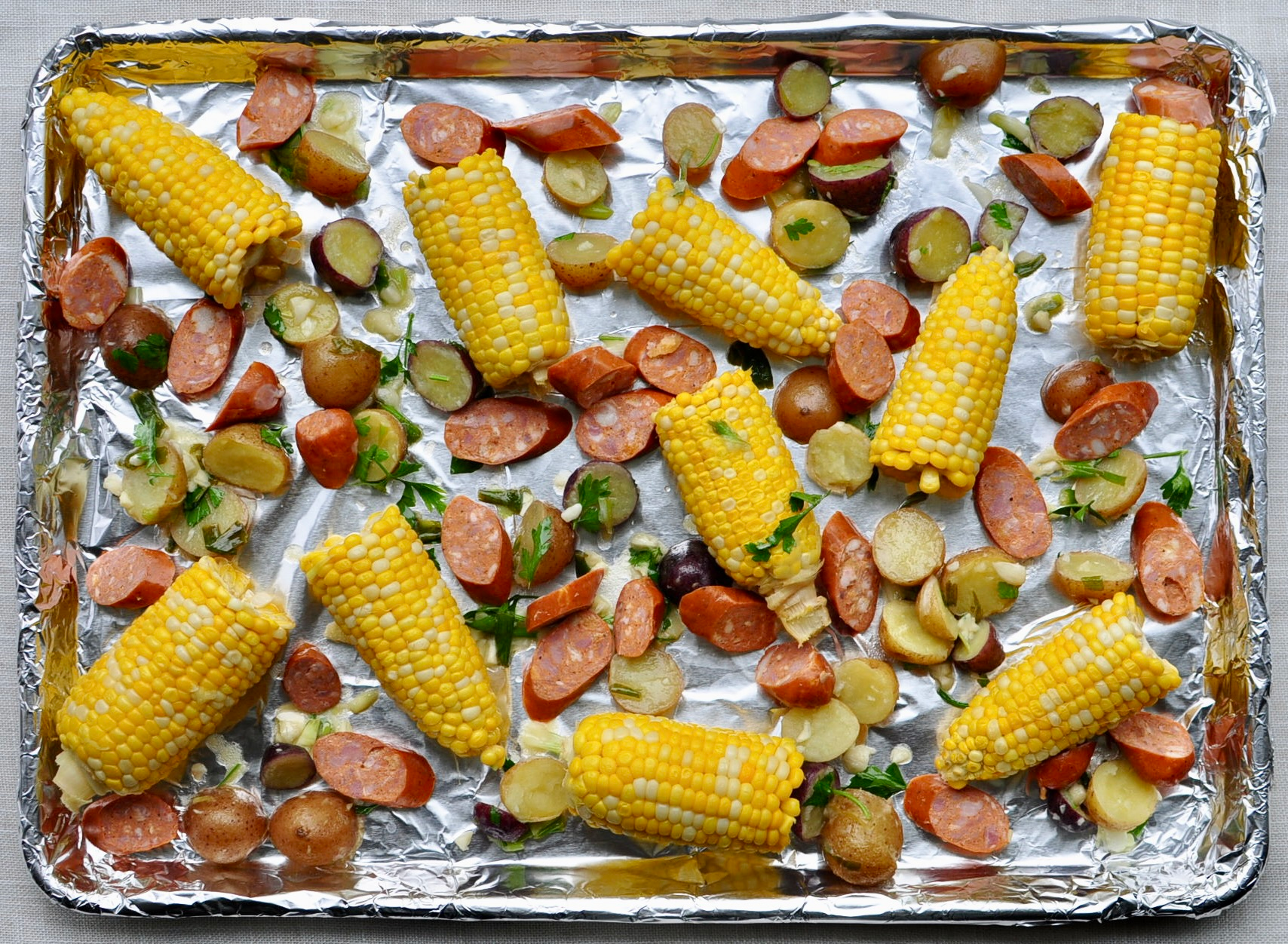 Sheet Pan Clam Bake Recipe with Corn, Little Potatoes and Andouille Sausage