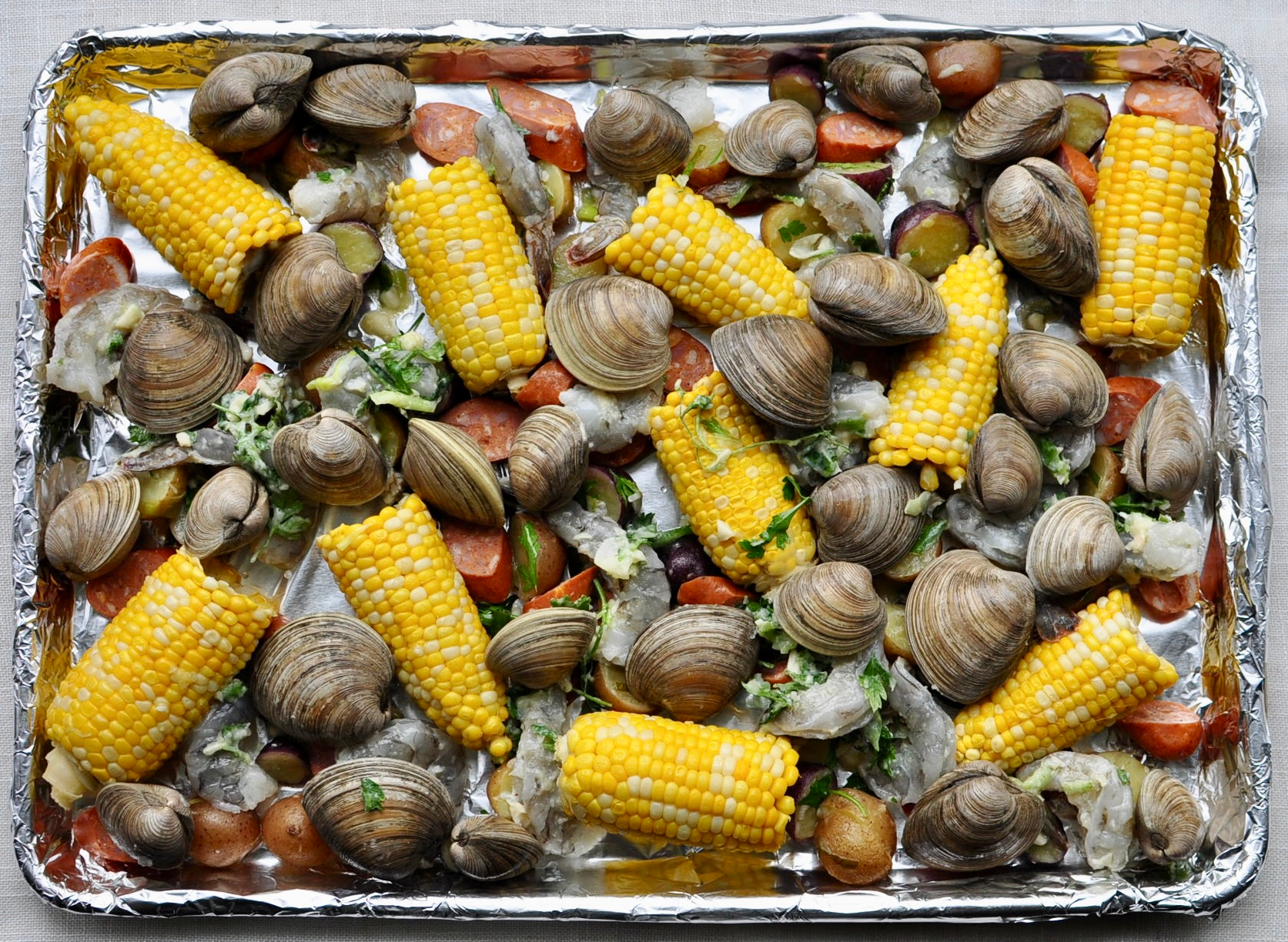 Sheet Pan Clam Bake with Corn, Potatoes, Andouille Sausage, Shrimp and Clams