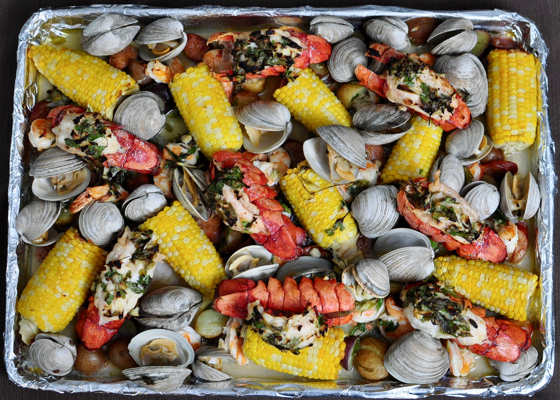 Sheet Pan Clam Bake with Lobster Tails, Shrimp, Clams, Corn, Sausage